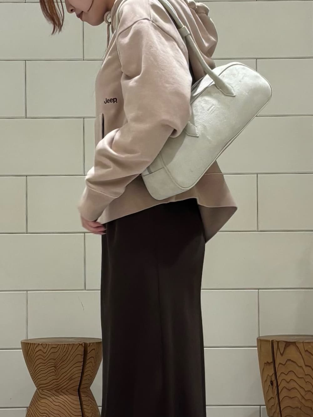 ホワイト系のスニーカー、ブラウン系のスカートを着用したレディースの冬コーディネートの4枚目の写真