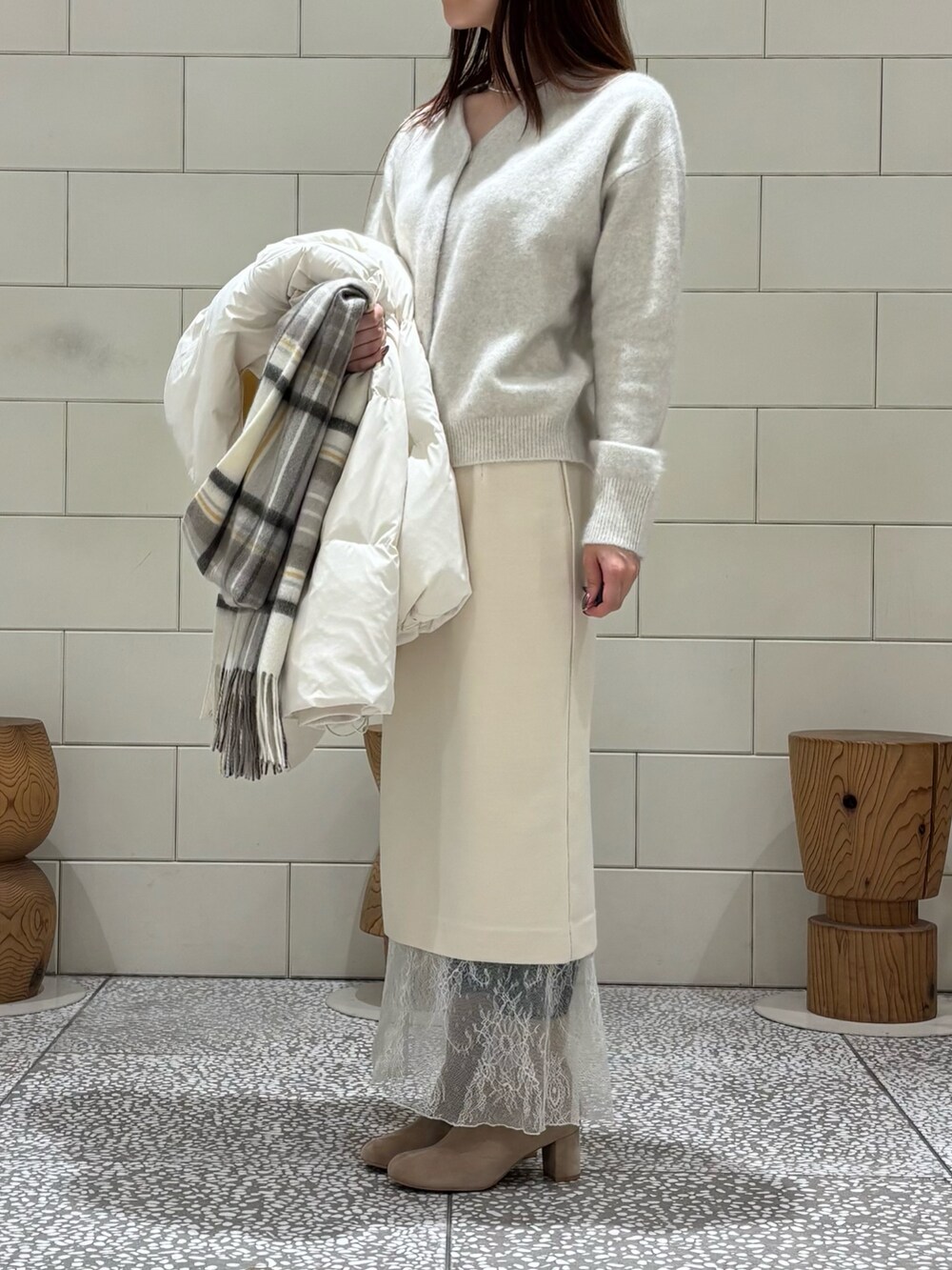 ホワイト系のダウンジャケット/コート、ホワイト系のカーディガン/ボレロ、ホワイト系のスカートを着用したレディースの秋コーディネートの7枚目の写真