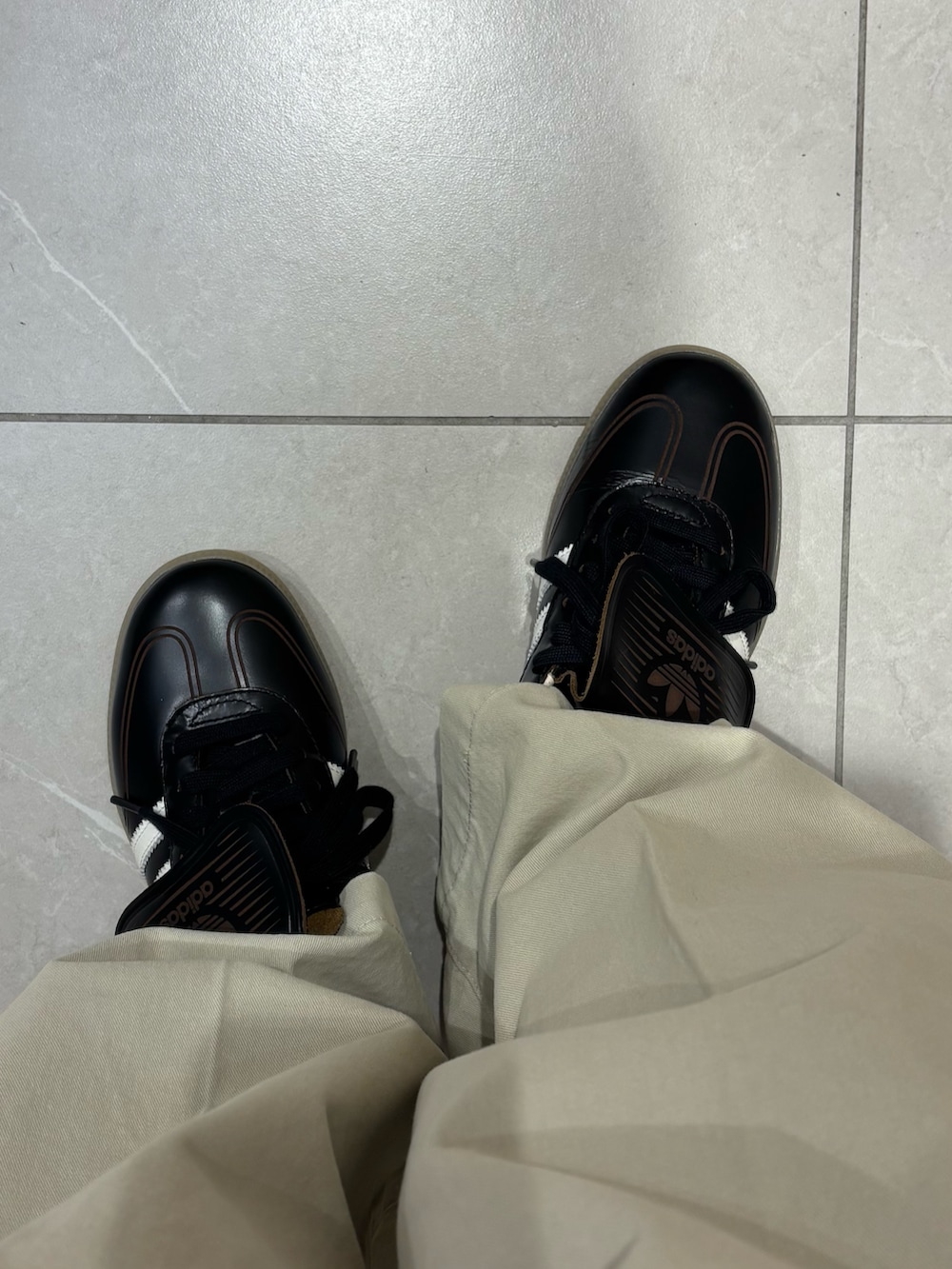 グレー系のニット/セーター、ブラウン系のトートバッグ、ブラック系のその他アウターを着用したレディースの冬コーディネートの5枚目の写真