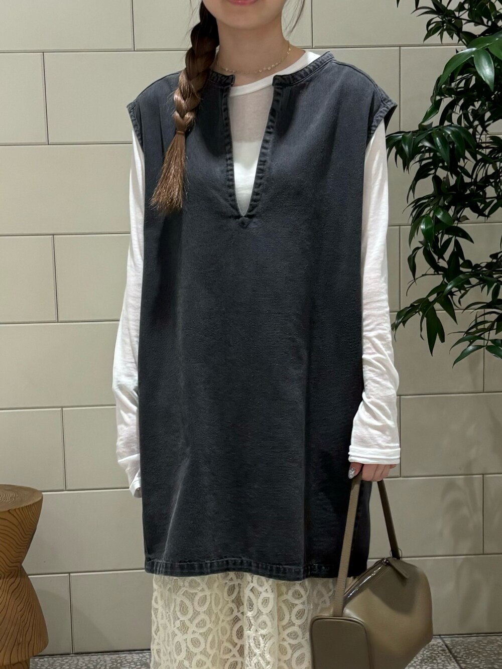 ホワイト系のTシャツ/カットソー、ブラック系のベスト、ベージュ系のハンドバッグを着用したレディースの夏コーディネートの5枚目の写真