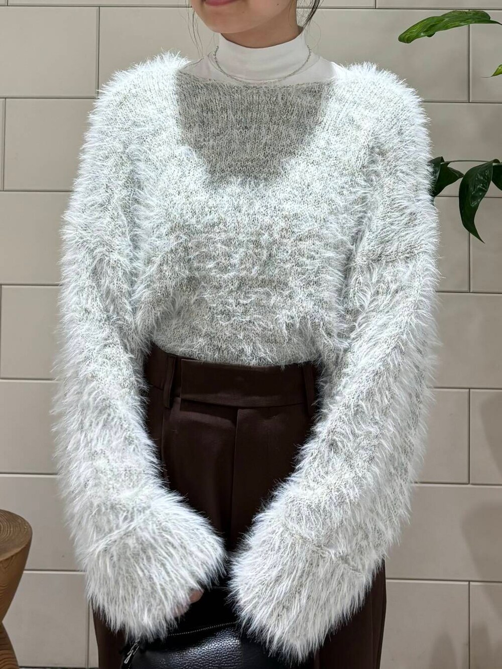 ブラウン系のその他パンツ、グレー系のニット/セーター、ブラック系のハンドバッグを着用したレディースの秋コーディネートの5枚目の写真