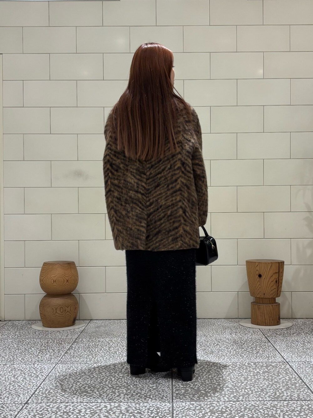 ホワイト系のTシャツ/カットソー、レッド系のニット/セーター、ベージュ系のピーコートを着用したレディースの秋コーディネートの3枚目の写真