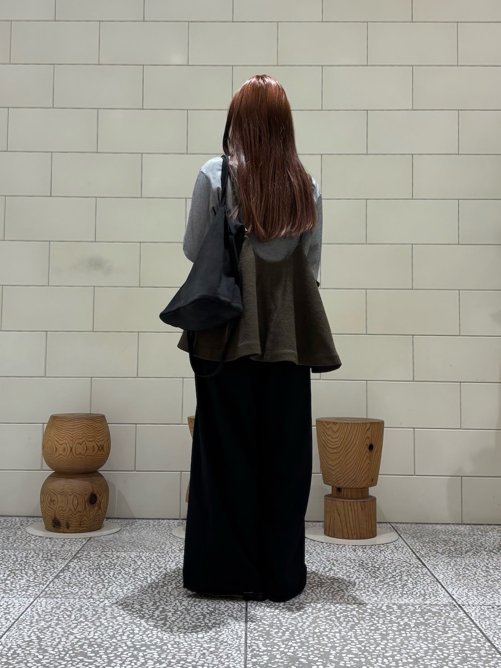 ブラック系のTシャツ/カットソー、ブラック系のその他パンツ、グリーン系のトートバッグを着用したレディースの秋コーディネートの2枚目の写真