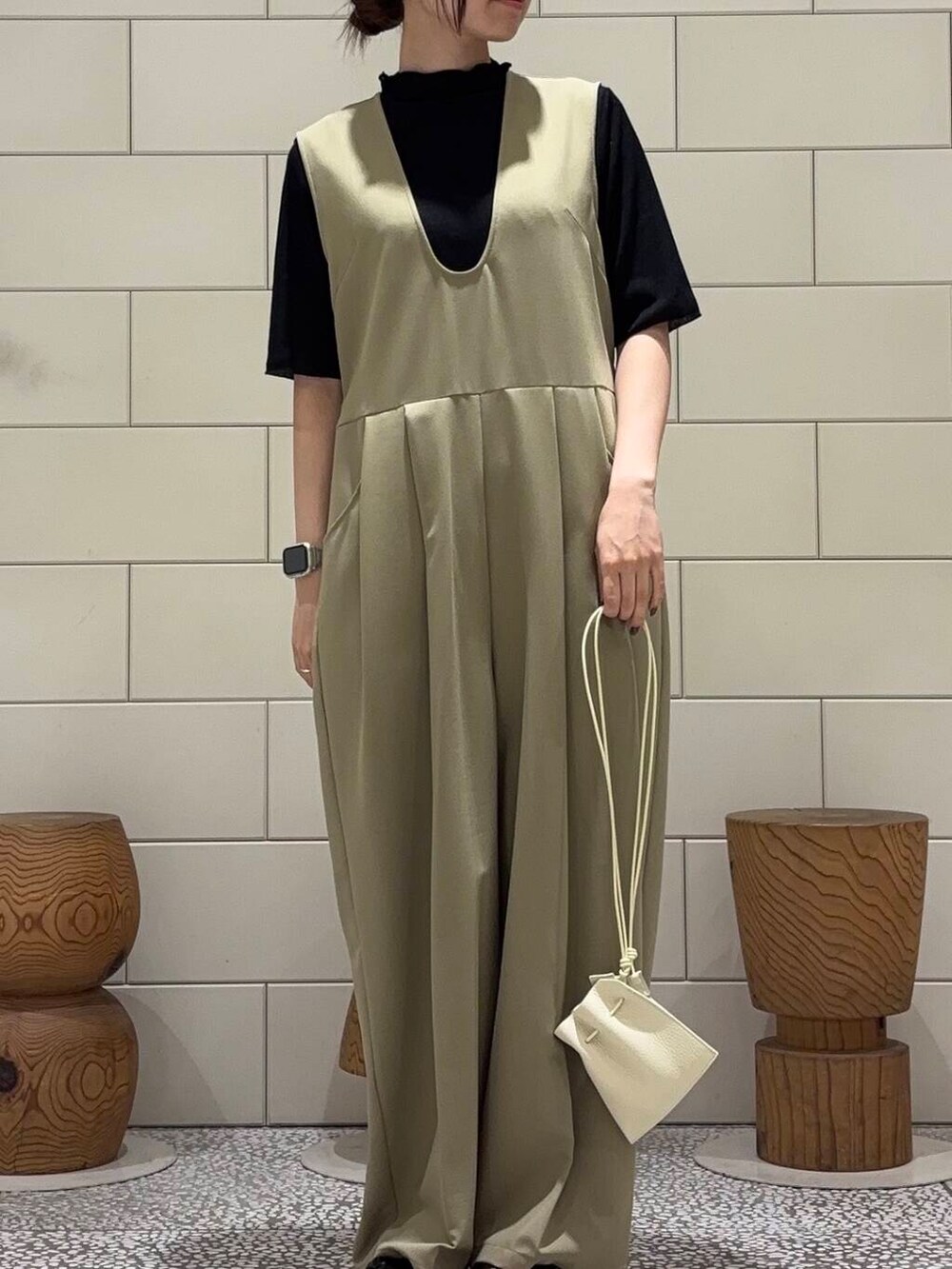 ベージュ系のサロペット/オーバーオール、ブラック系のTシャツ/カットソーを着用したレディースの夏コーディネートの3枚目の写真