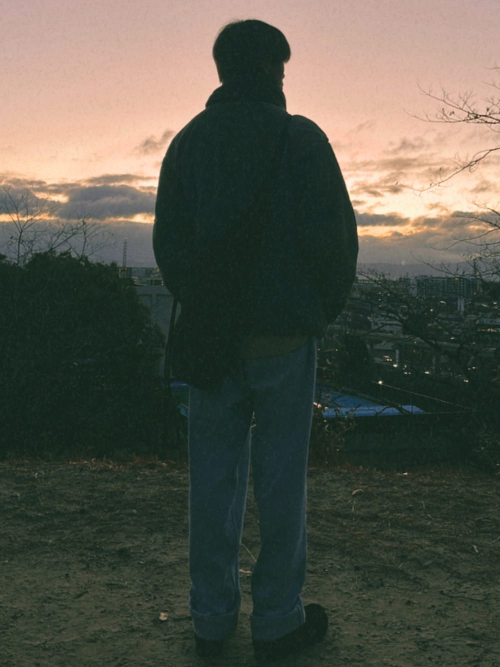 ブルー系のデニムパンツ、グリーン系のミリタリージャケット、ブラック系のモカシン/デッキシューズを着用したメンズの冬コーディネートの3枚目の写真