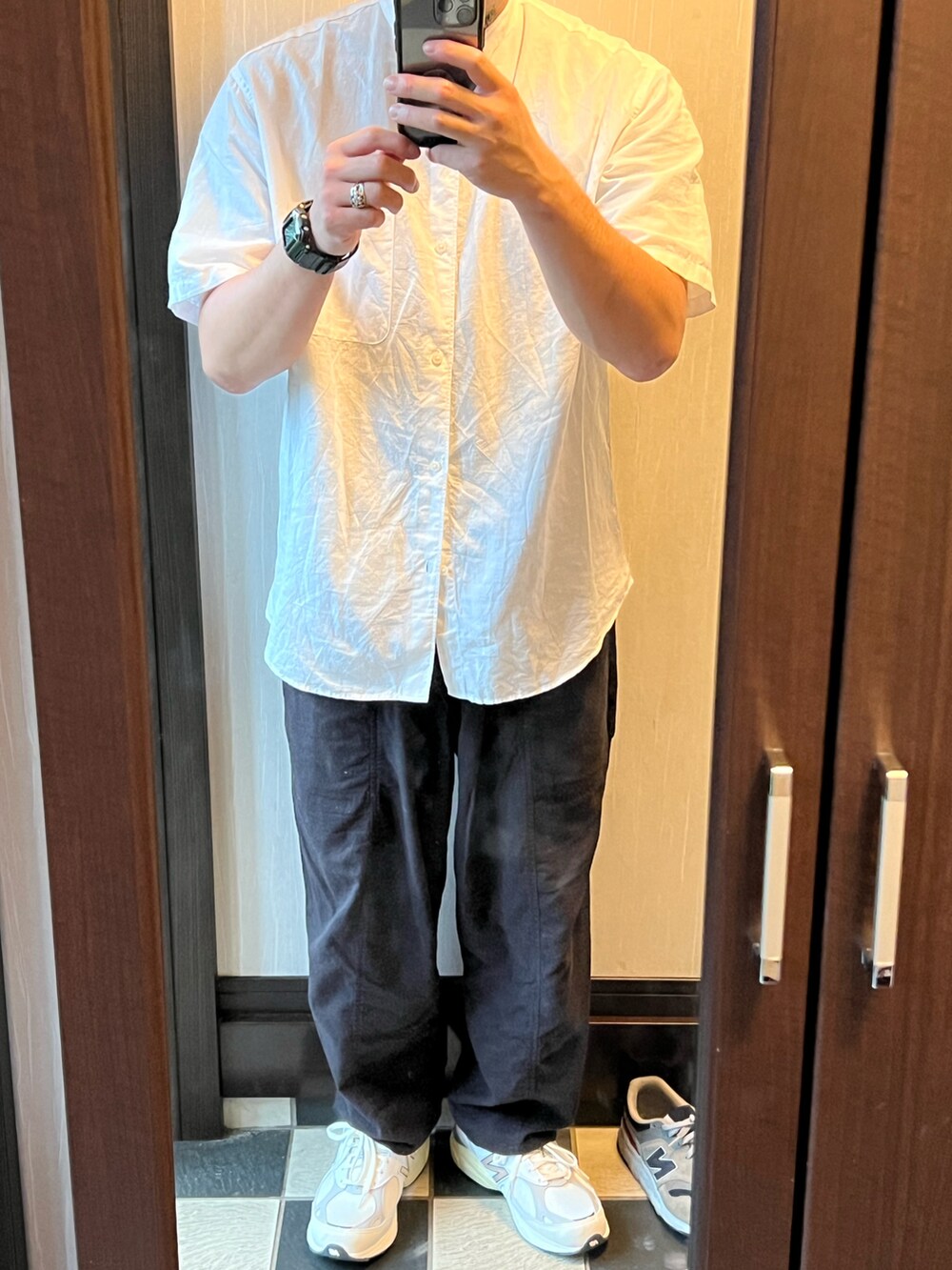 ブラック系のセットアップ、ホワイト系のスニーカー、ホワイト系のシャツ/ブラウスを着用したメンズの秋コーディネートの2枚目の写真