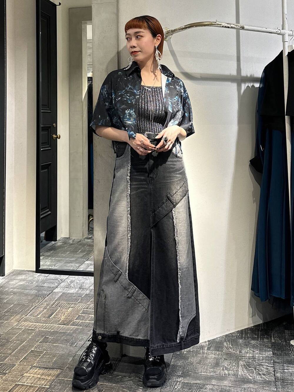 ブラック系のタンクトップ、ブラック系のサンダル、ブラック系のデニムスカートを着用したレディースの春コーディネートの3枚目の写真