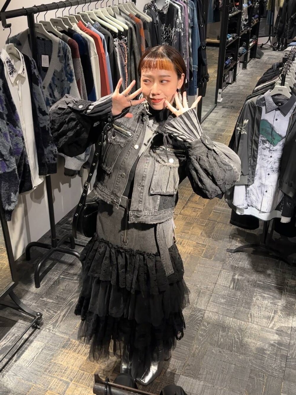 シルバー系のブーツ、ブラック系のニット/セーター、ブラック系のショルダーバッグを着用したレディースの秋コーディネートの5枚目の写真