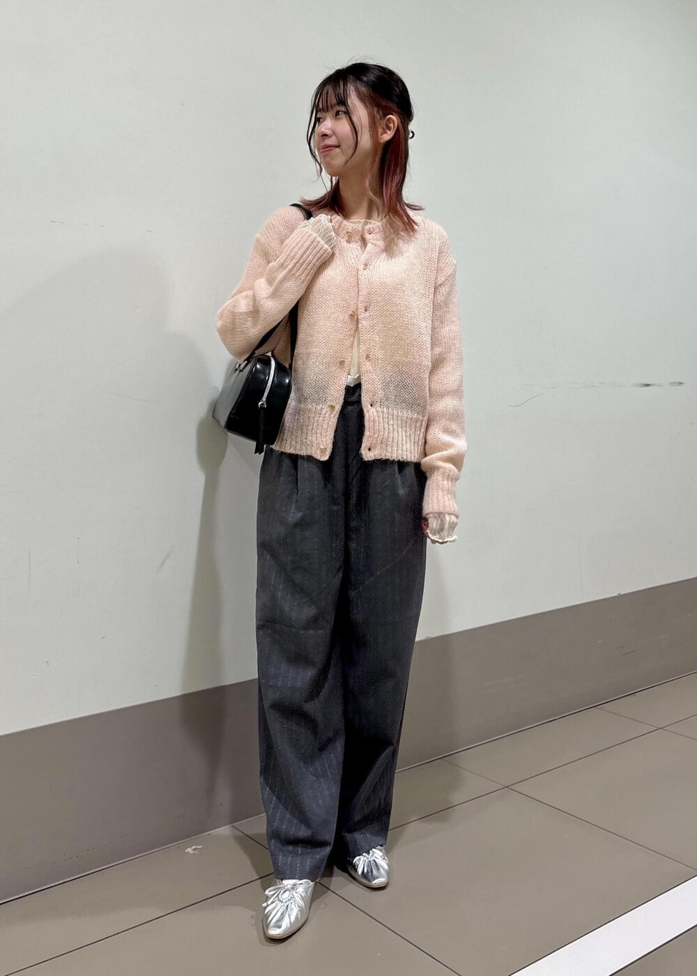 シルバー系のパンプス、ピンク系のカーディガン/ボレロ、グレー系のその他パンツを着用したレディースの冬コーディネートの2枚目の写真
