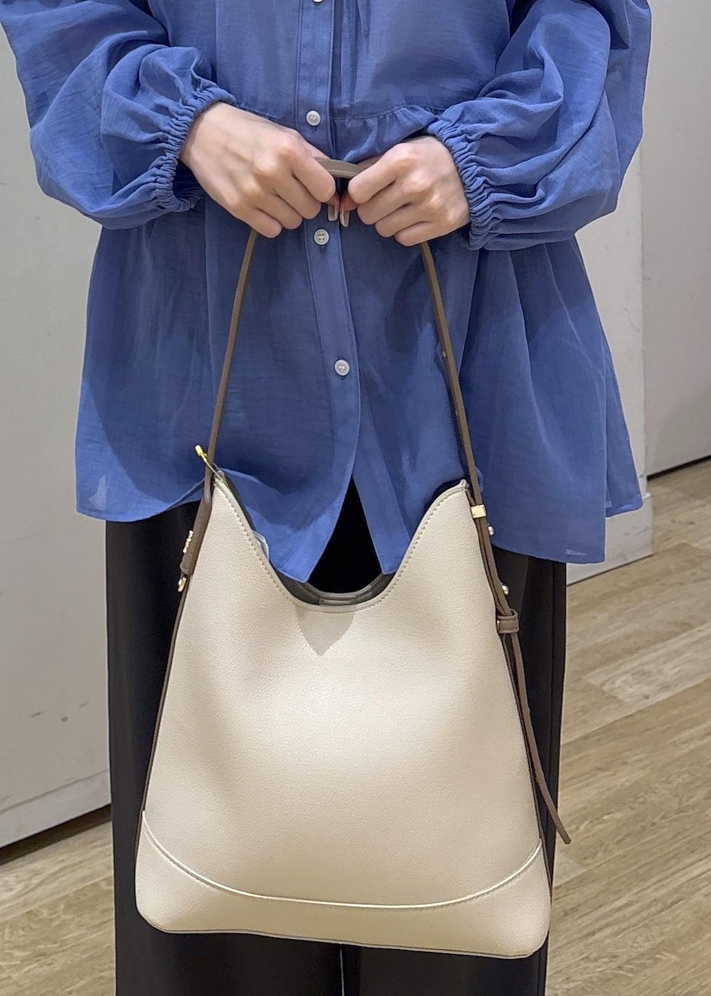 ホワイト系のショルダーバッグ、ブラック系のローファー、グレー系のその他パンツを着用したレディースの春コーディネートの7枚目の写真