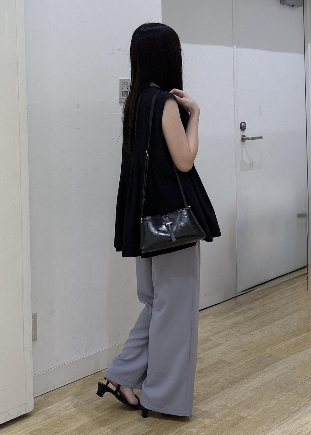 ブラック系のショルダーバッグ、ブラック系のサンダル、ブルー系のその他パンツを着用したレディースの夏コーディネートの3枚目の写真
