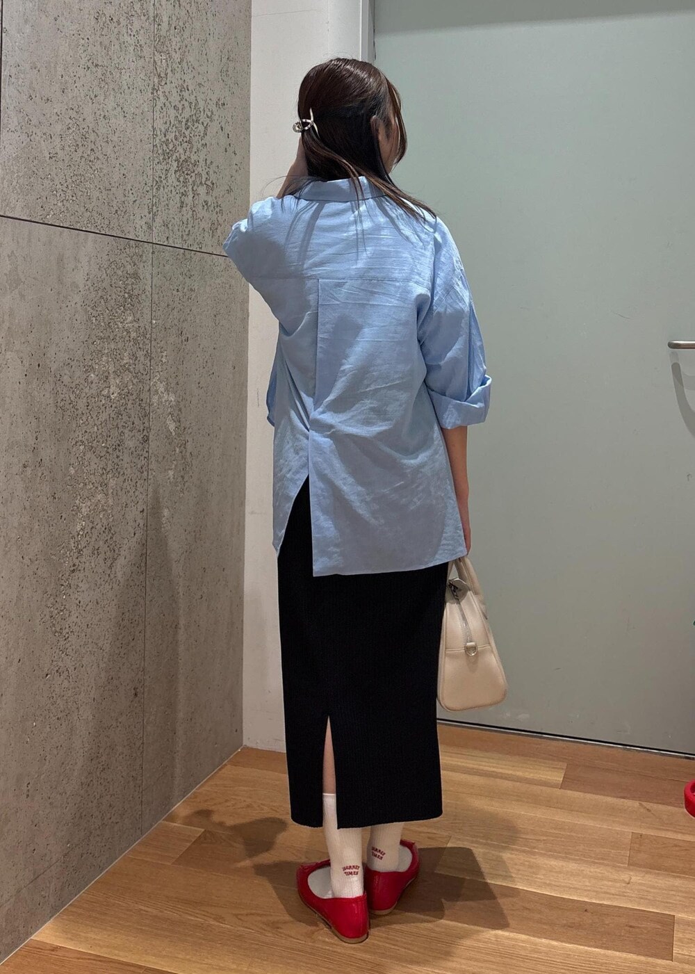 ブラック系のスカート、ブルー系のシャツ/ブラウス、ホワイト系のTシャツ/カットソーを着用したレディースの春コーディネートの4枚目の写真