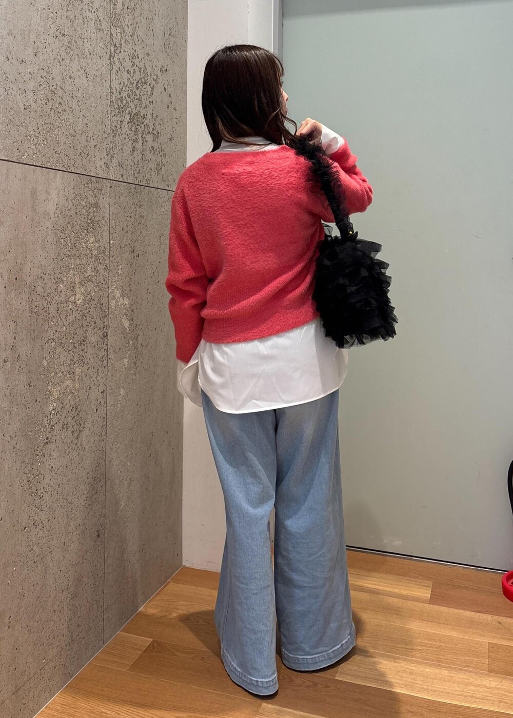 ブルー系のデニムパンツ、ホワイト系のシャツ/ブラウス、ピンク系のニット/セーターを着用したレディースの冬コーディネートの4枚目の写真