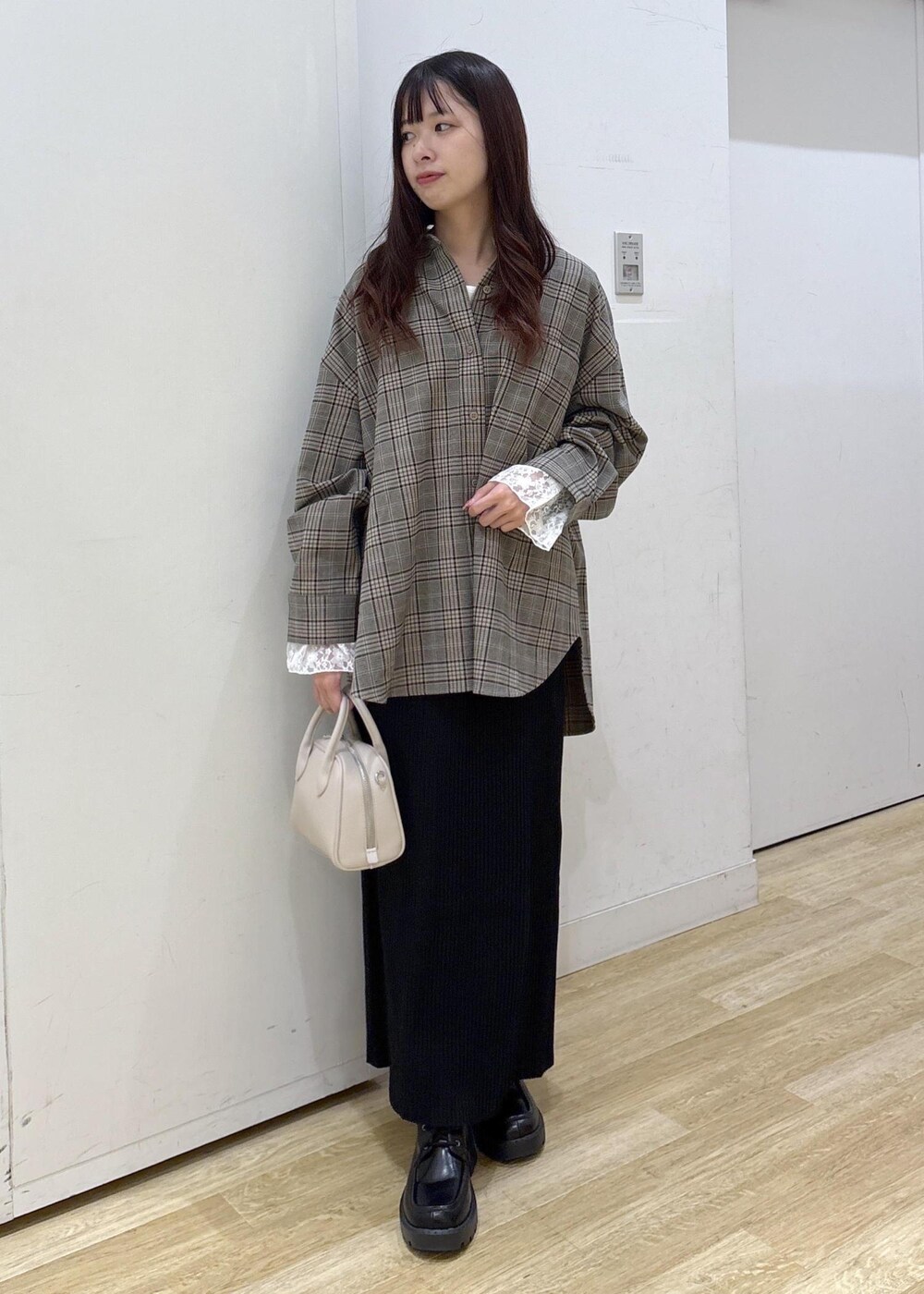 ベージュ系のシャツ/ブラウス、ホワイト系のTシャツ/カットソー、ブラック系のスカートを着用したレディースの秋コーディネートの2枚目の写真