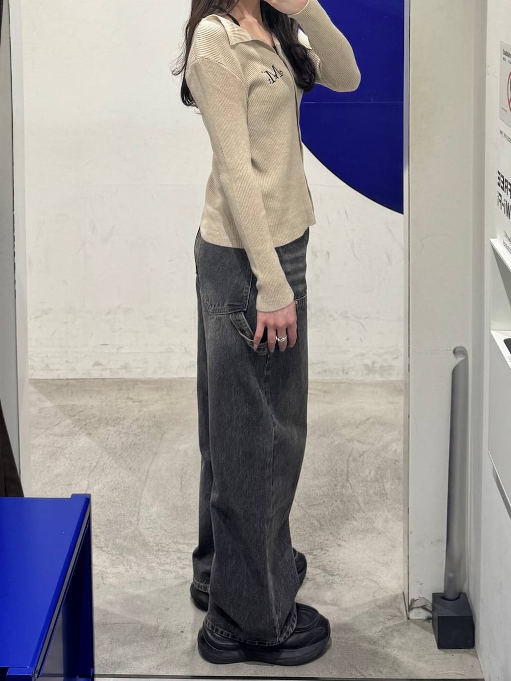 ブラック系のデニムパンツ、ブラウン系のカーディガン/ボレロを着用したレディースの春コーディネートの2枚目の写真