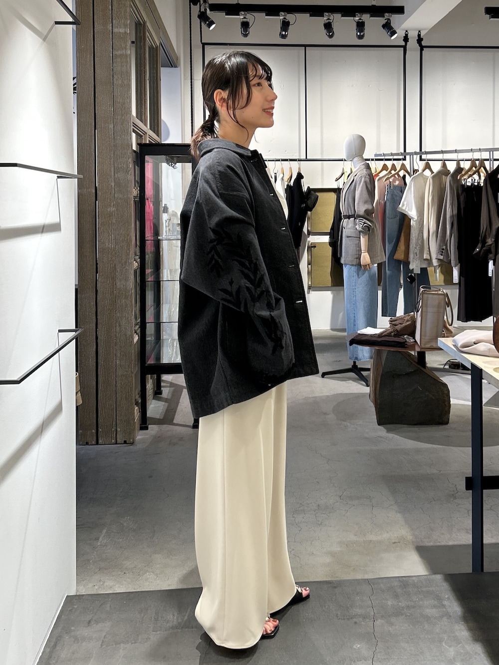 ホワイト系のTシャツ/カットソー、ベージュ系のその他パンツ、ブラック系のデニムジャケットを着用したレディースの春コーディネートの2枚目の写真