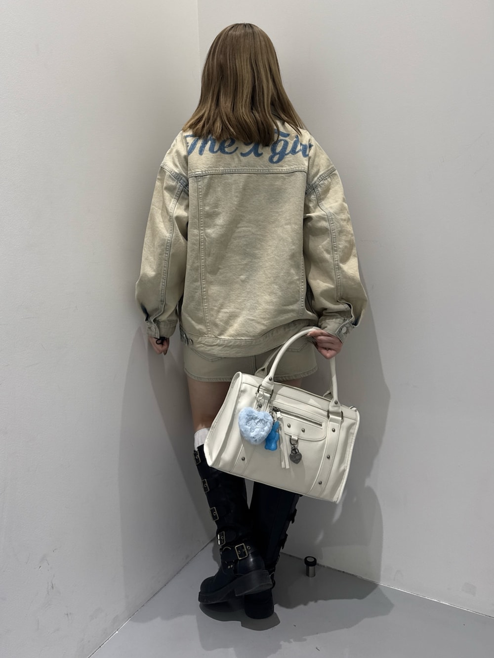 ブルー系のデニムジャケット、ホワイト系のTシャツ/カットソー、ブルー系のデニムスカートを着用したレディースの冬コーディネートの3枚目の写真