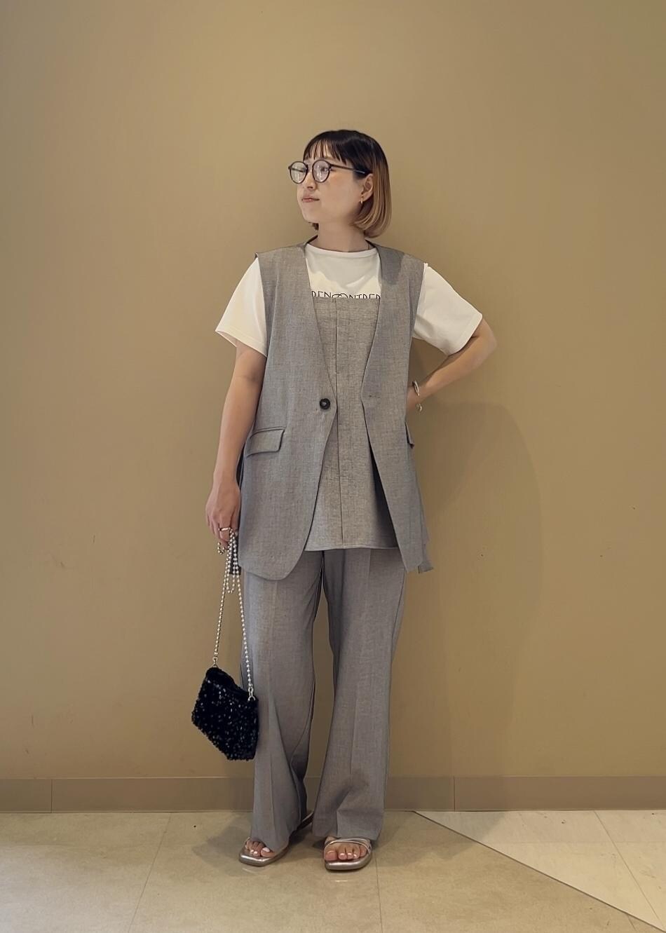 グレー系のキャミソール、ホワイト系のTシャツ/カットソー、グレー系のその他パンツを着用したレディースの春コーディネートの4枚目の写真