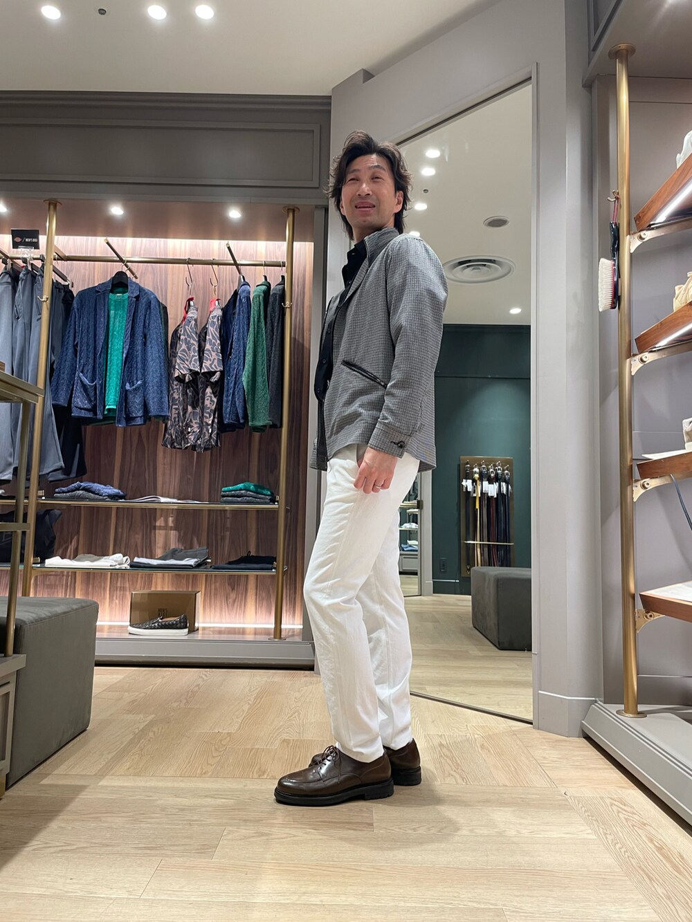 ブラウン系のドレスシューズ、ホワイト系のその他パンツ、ブラック系のブルゾンを着用したメンズの春コーディネートの3枚目の写真