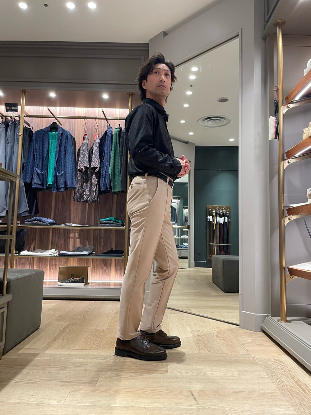 ブラック系のシャツ/ブラウス、ベージュ系のスラックス、ブラウン系のドレスシューズを着用したメンズの春コーディネートの3枚目の写真