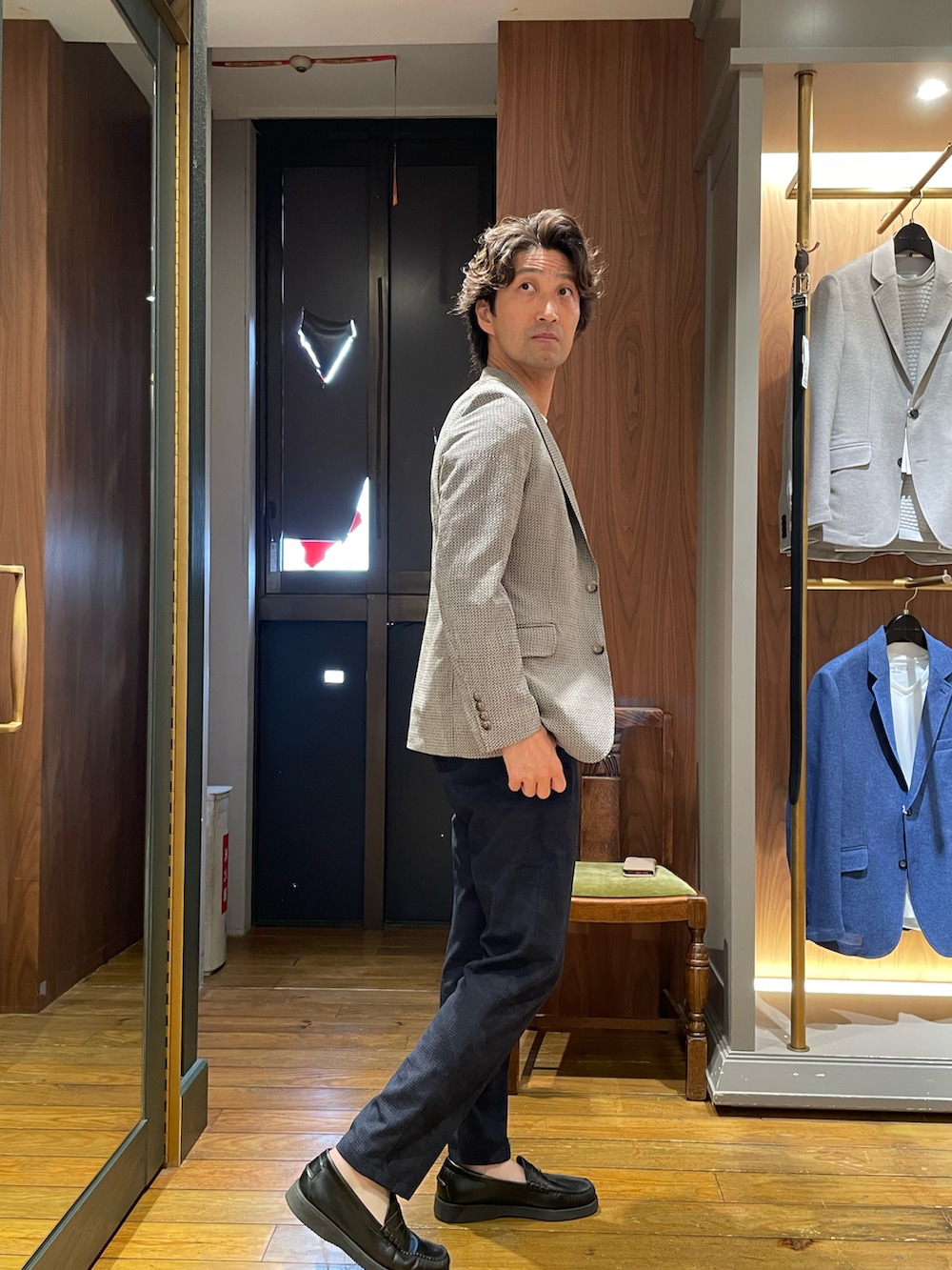 グレー系のテーラードジャケット、ブルー系のスラックス、ホワイト系のTシャツ/カットソーを着用したメンズの夏コーディネートの2枚目の写真