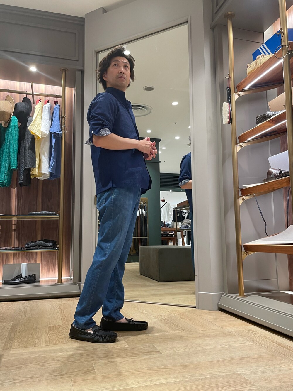 ブルー系のシャツ/ブラウス、ブルー系のデニムパンツ、ブラック系のモカシン/デッキシューズを着用したメンズの夏コーディネートの2枚目の写真