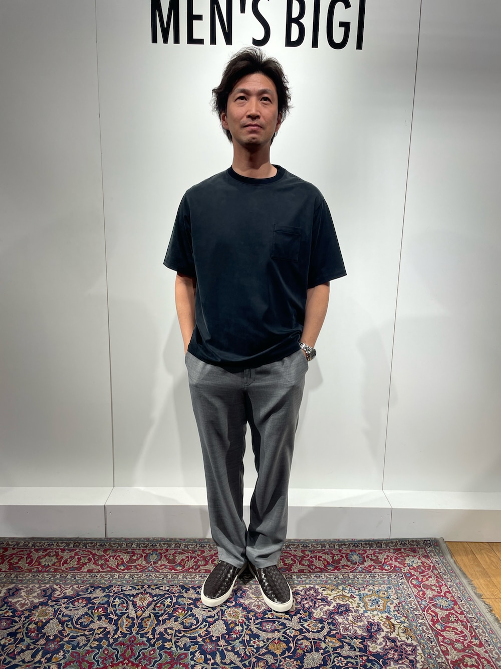 ブラック系のTシャツ/カットソー、グレー系のその他パンツ、ブラウン系のスリッポンを着用したメンズの春コーディネートの3枚目の写真