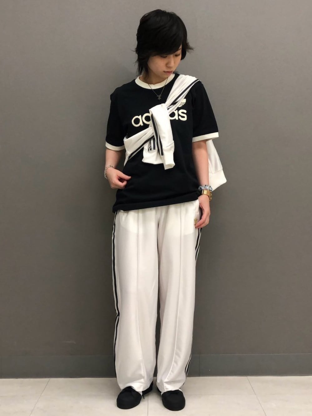 ブラック系のトップス、ホワイト系のジャージ、ホワイト系のその他パンツを着用したレディースの春コーディネートの3枚目の写真