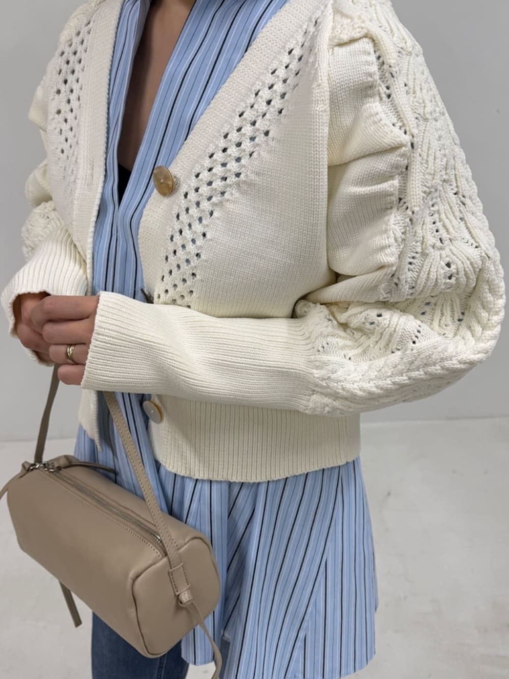 ブルー系のデニムパンツ、ホワイト系のカーディガン/ボレロ、ブルー系のシャツ/ブラウスを着用したレディースの冬コーディネートの3枚目の写真