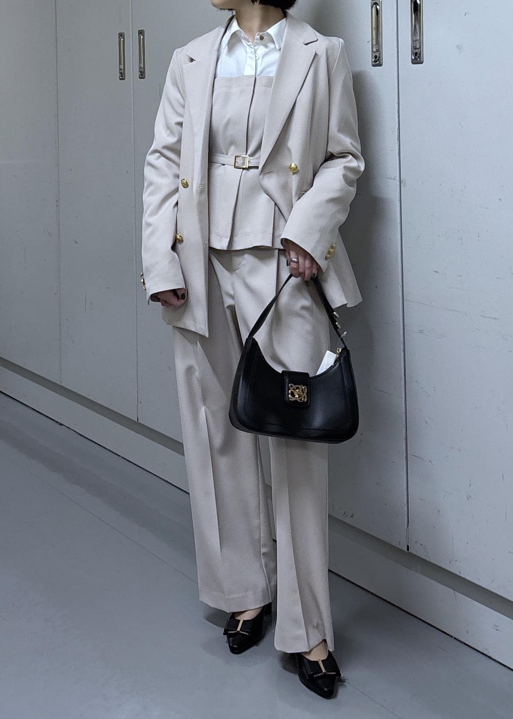 ブラック系のショルダーバッグ、ブラック系のパンプス、ベージュ系のその他パンツを着用したレディースの冬コーディネートの7枚目の写真