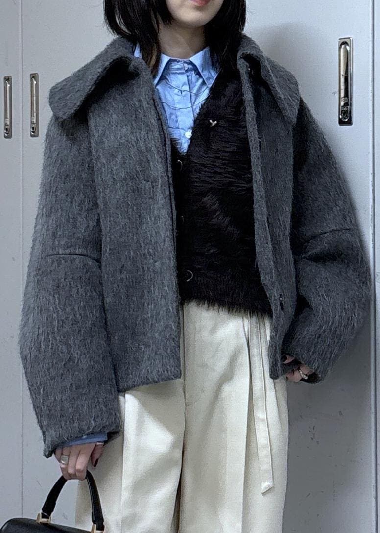 グレー系のカーディガン/ボレロ、グレー系のブルゾン、ブラック系のブーツを着用したレディースの冬コーディネートの6枚目の写真