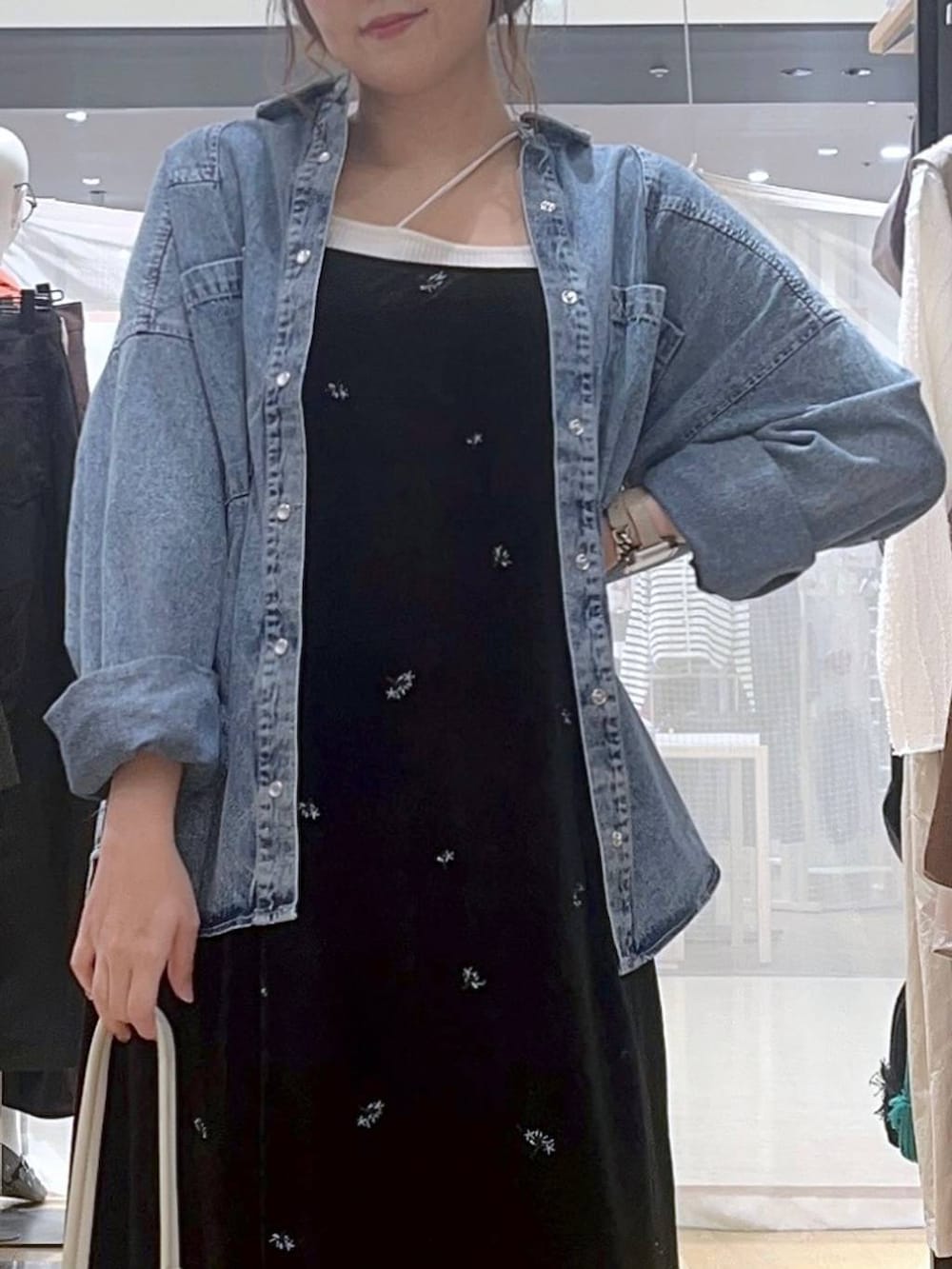 ブルー系のシャツ/ブラウス、ベージュ系のキャミソール、ホワイト系のショルダーバッグを着用したレディースの秋コーディネートの7枚目の写真