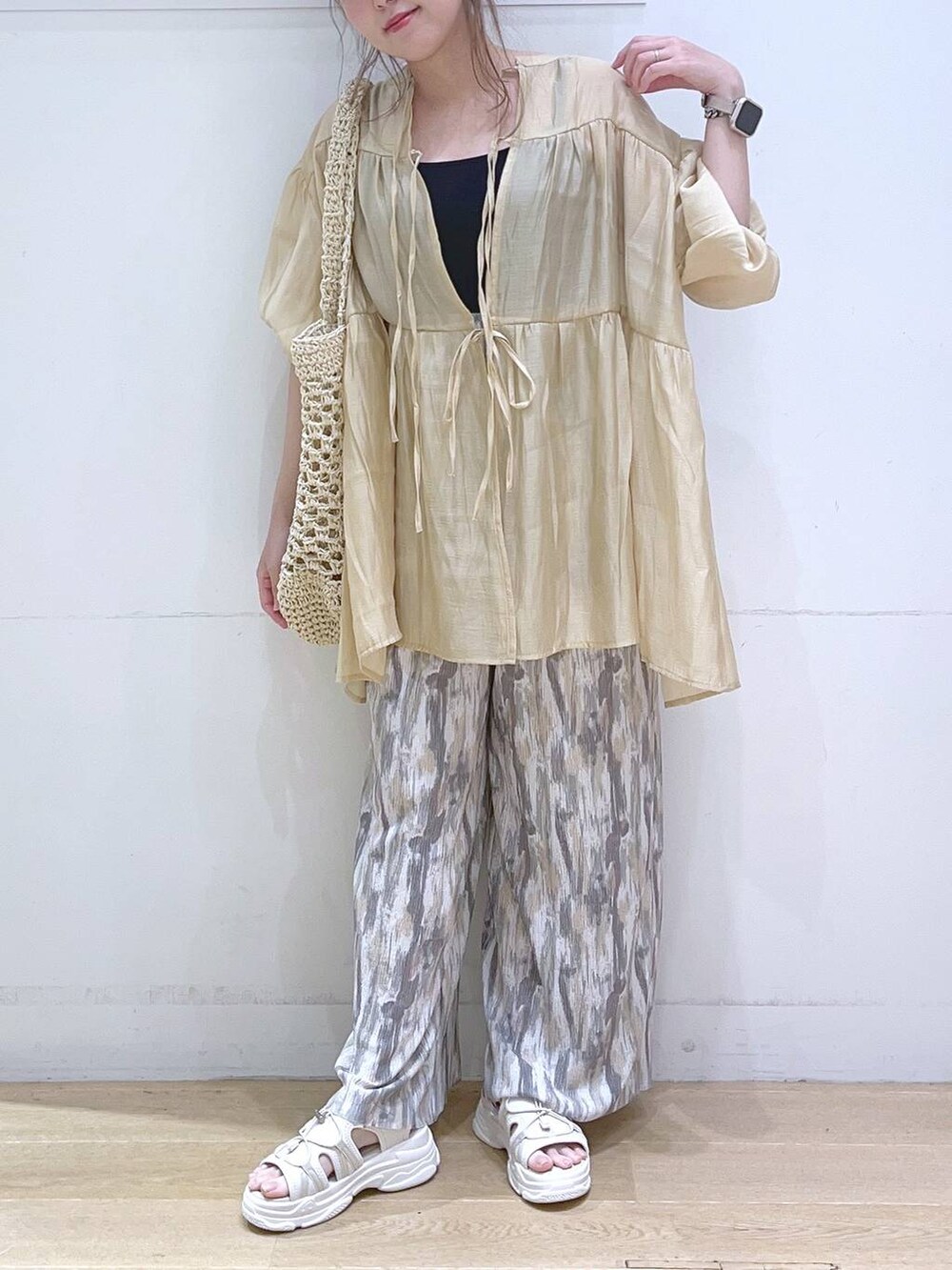 ホワイト系のサンダル、ホワイト系のトートバッグ、ベージュ系のその他パンツを着用したレディースの春コーディネートの2枚目の写真