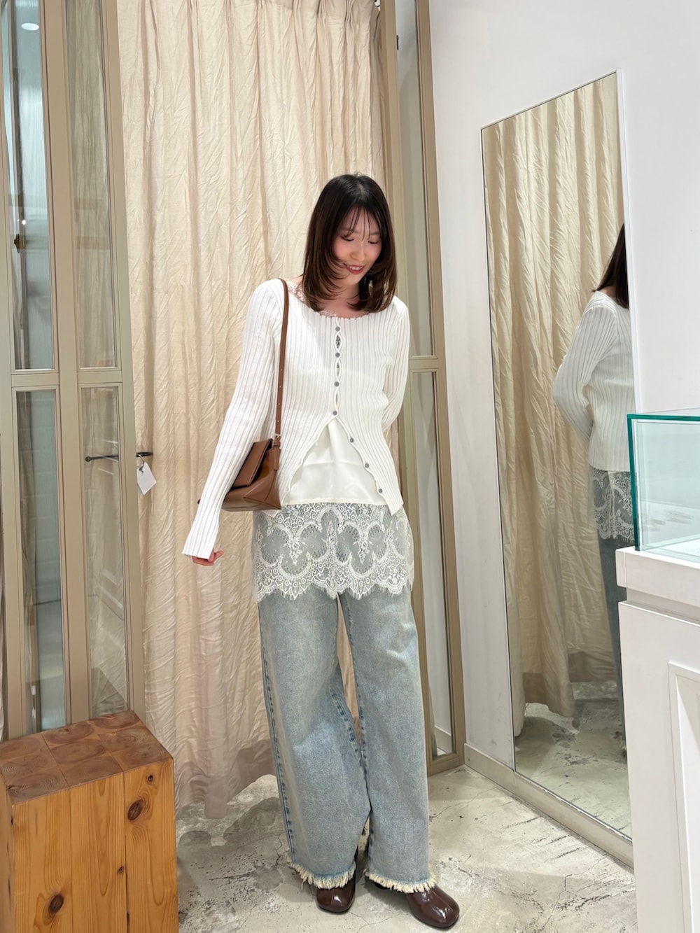 ホワイト系のシャツ/ブラウス、ブルー系のデニムパンツ、イエロー系のショルダーバッグを着用したレディースの冬コーディネートの2枚目の写真