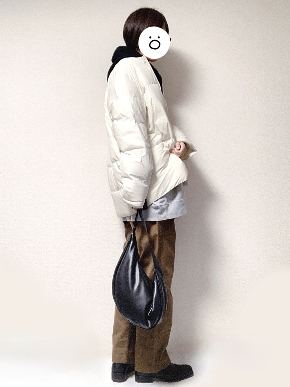 グレー系のスウェット、ブラック系のショルダーバッグ、ブラウン系のチノパンツを着用したレディースの秋コーディネートの2枚目の写真