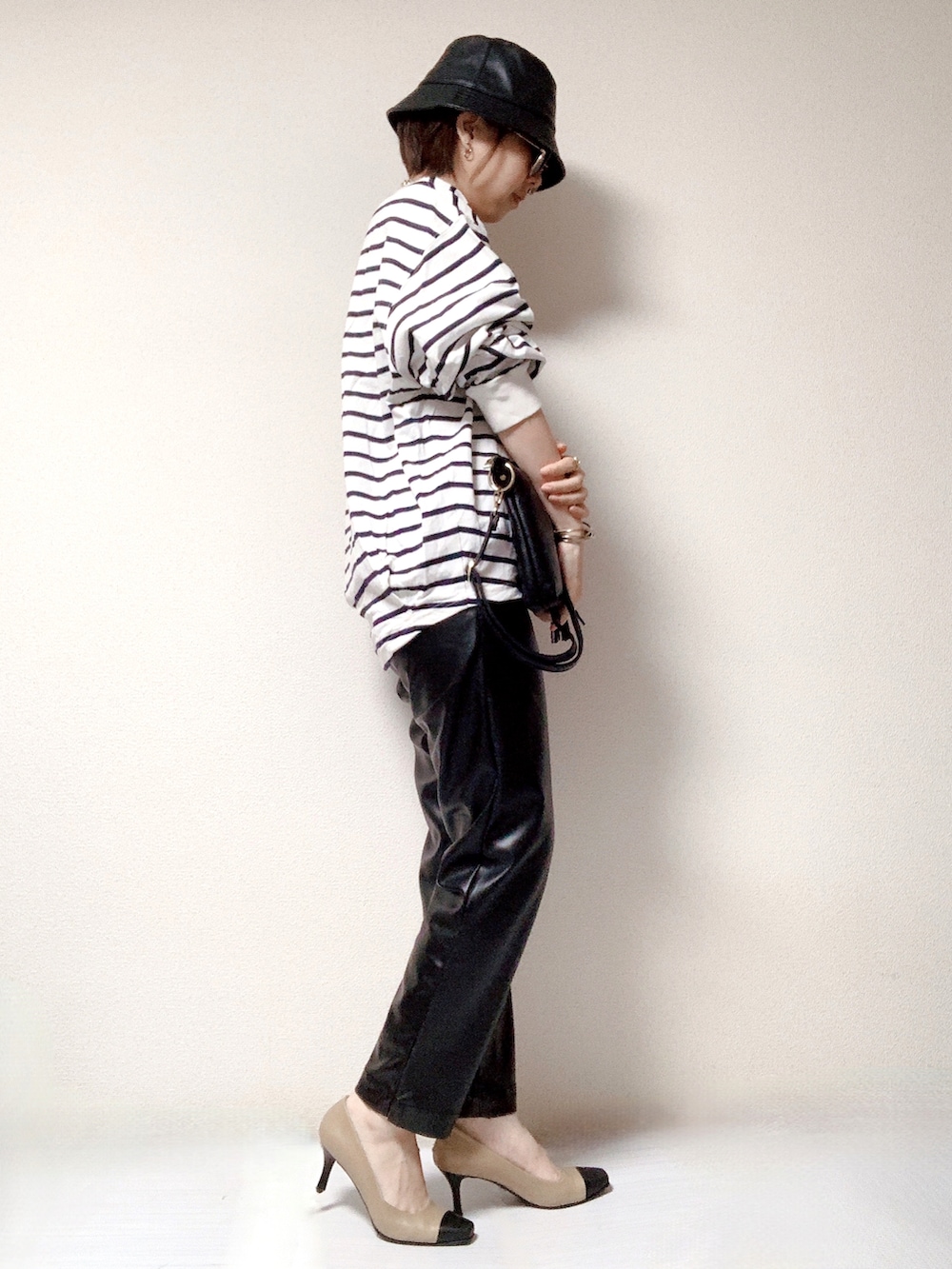 ブルー系のTシャツ/カットソー、ベージュ系のパンプス、ブラック系のショルダーバッグを着用したレディースの秋コーディネートの2枚目の写真