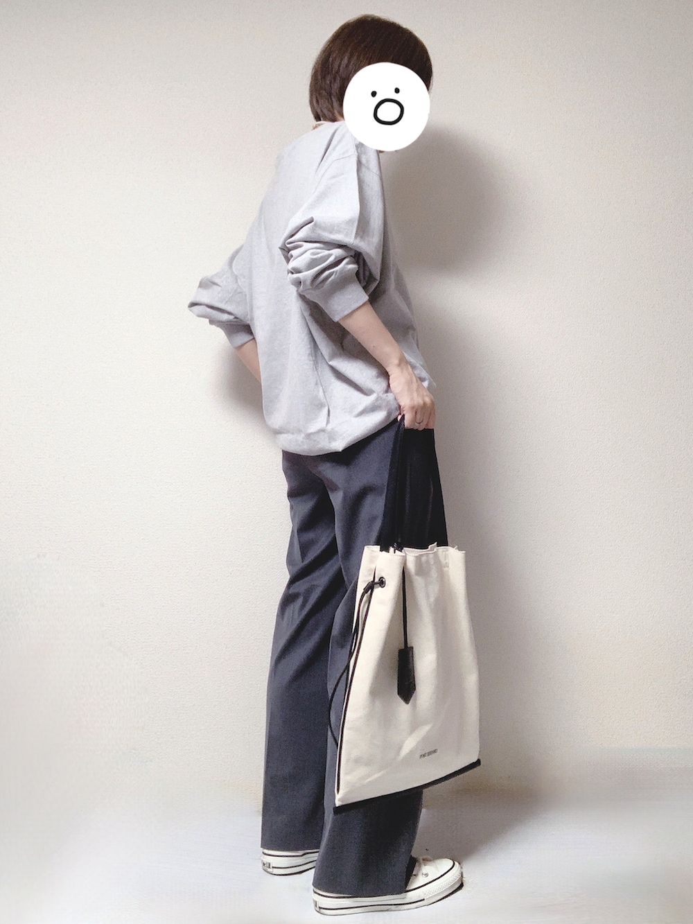 ホワイト系のスニーカー、グレー系のスラックス、グレー系のTシャツ/カットソーを着用したレディースの秋コーディネートの2枚目の写真