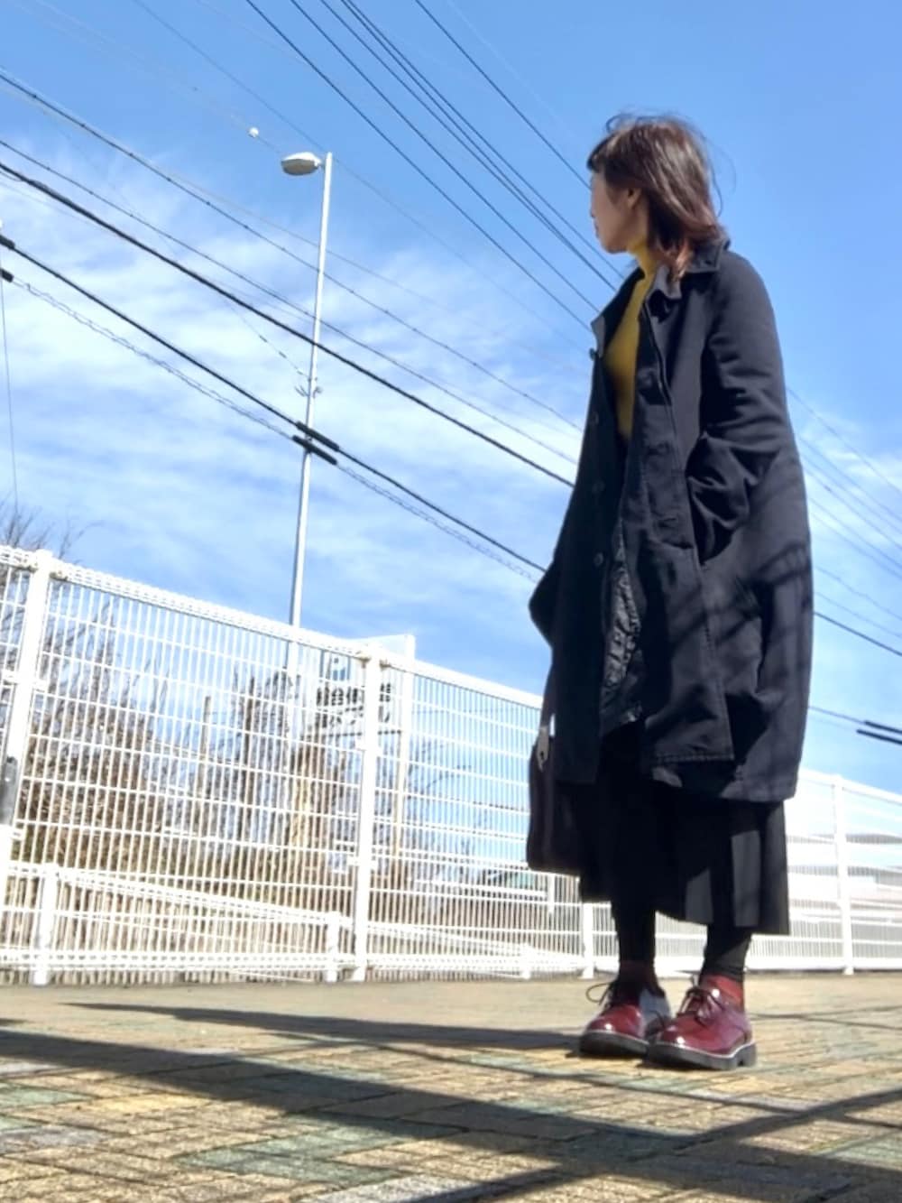 ブラック系のジャケット/アウター、ブラック系のスカート、ブラウン系のドレスシューズを着用したレディースの春コーディネートの2枚目の写真