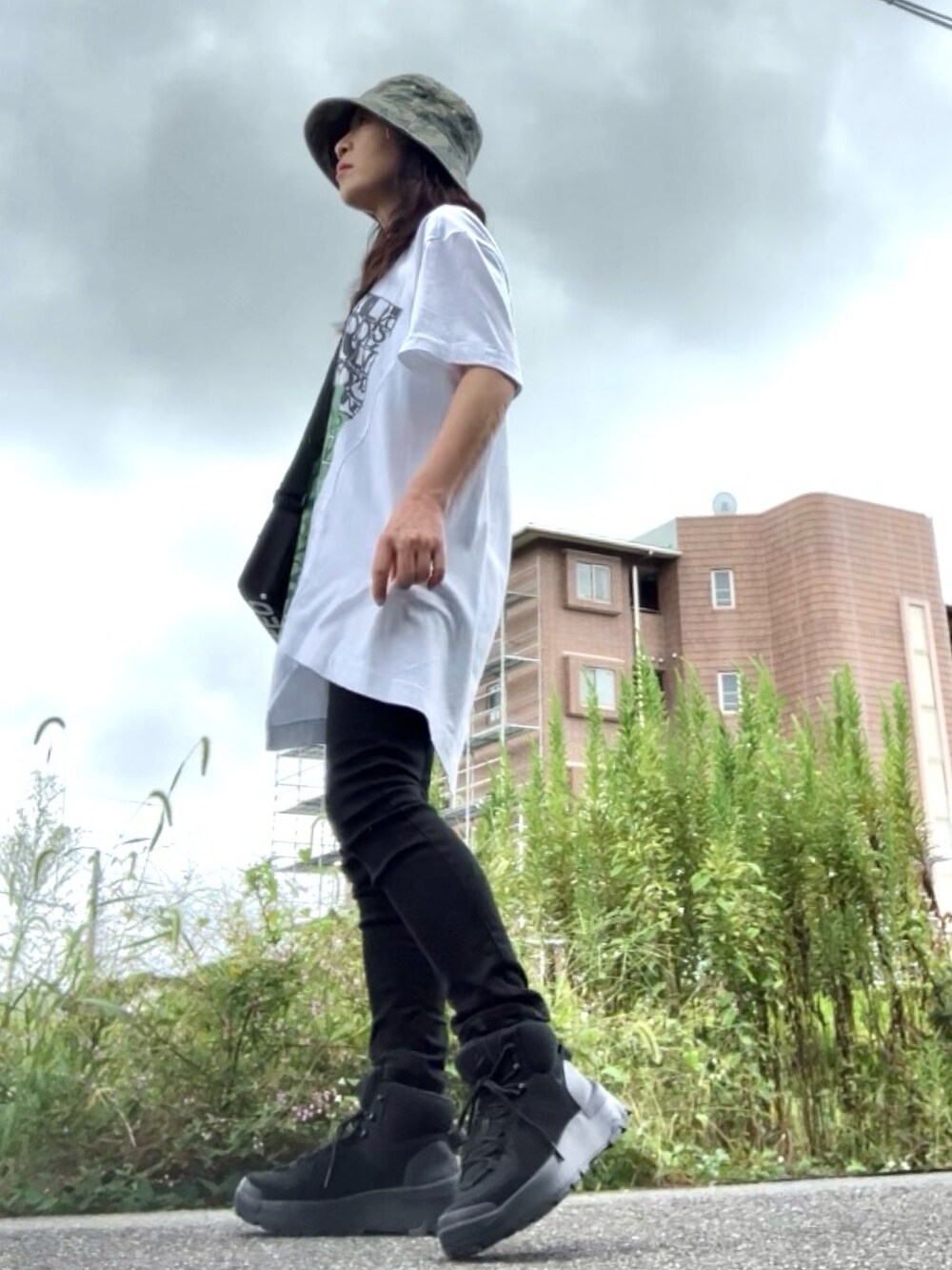 ホワイト系のTシャツ/カットソー、ブラック系のデニムパンツ、ブラック系のショルダーバッグを着用したレディースの秋コーディネートの2枚目の写真