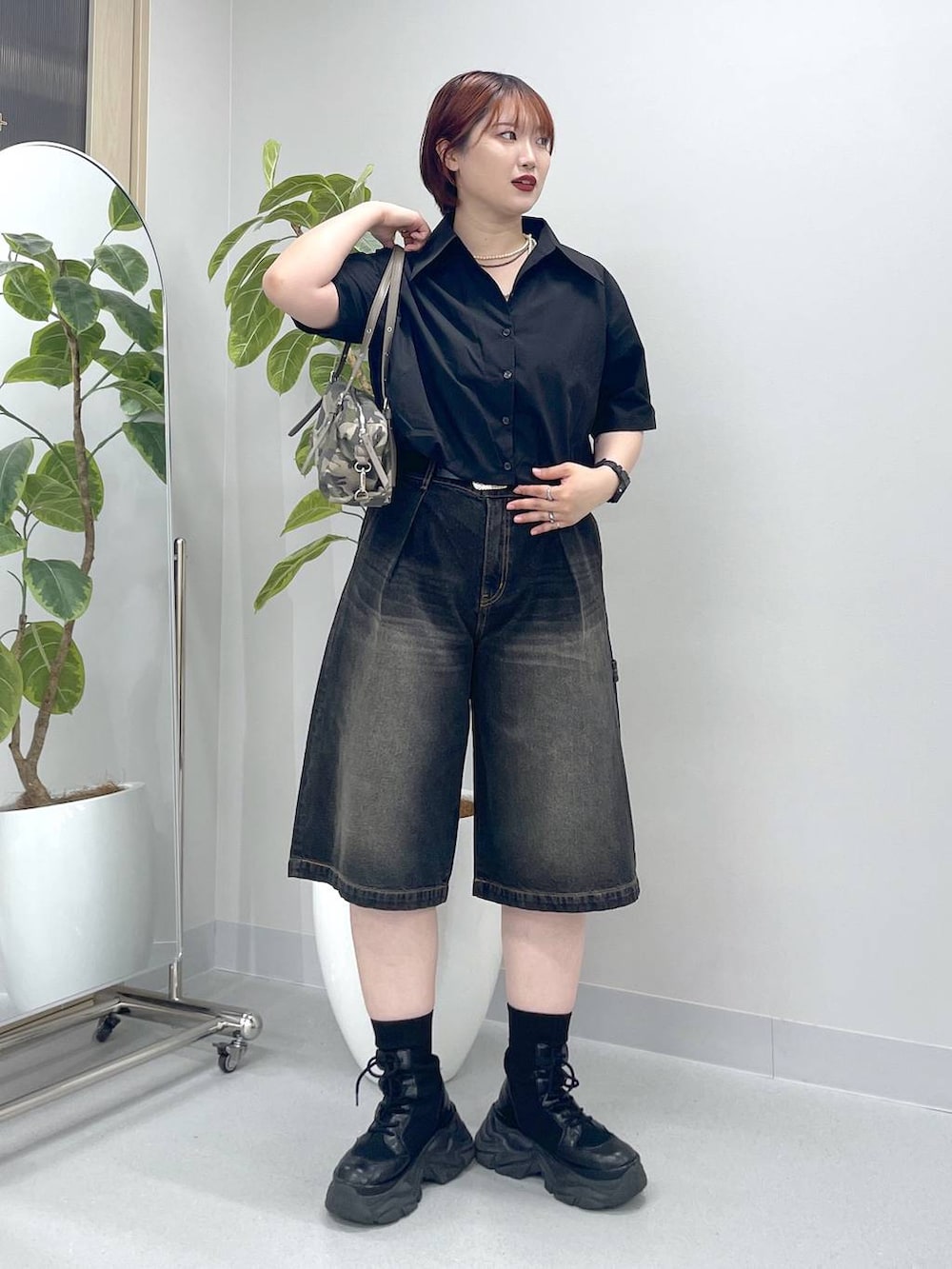 ブラック系のブーツ、ブラック系のデニムパンツ、ブラック系のシャツ/ブラウスを着用したレディースの春コーディネートの4枚目の写真