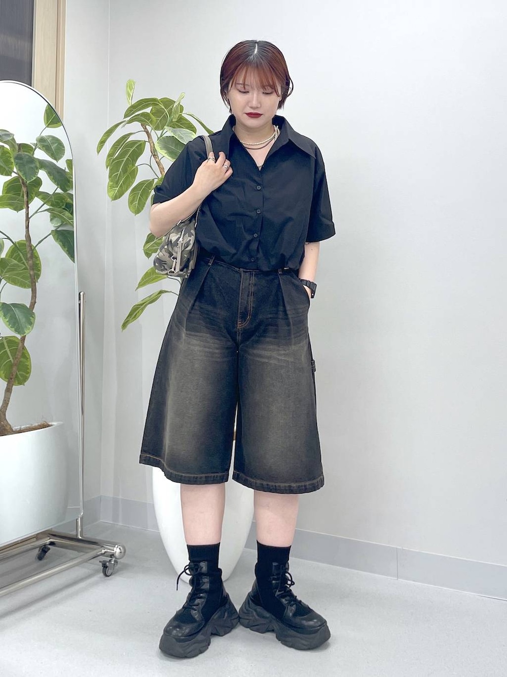 ブラック系のブーツ、ブラック系のデニムパンツ、ブラック系のシャツ/ブラウスを着用したレディースの春コーディネートの3枚目の写真