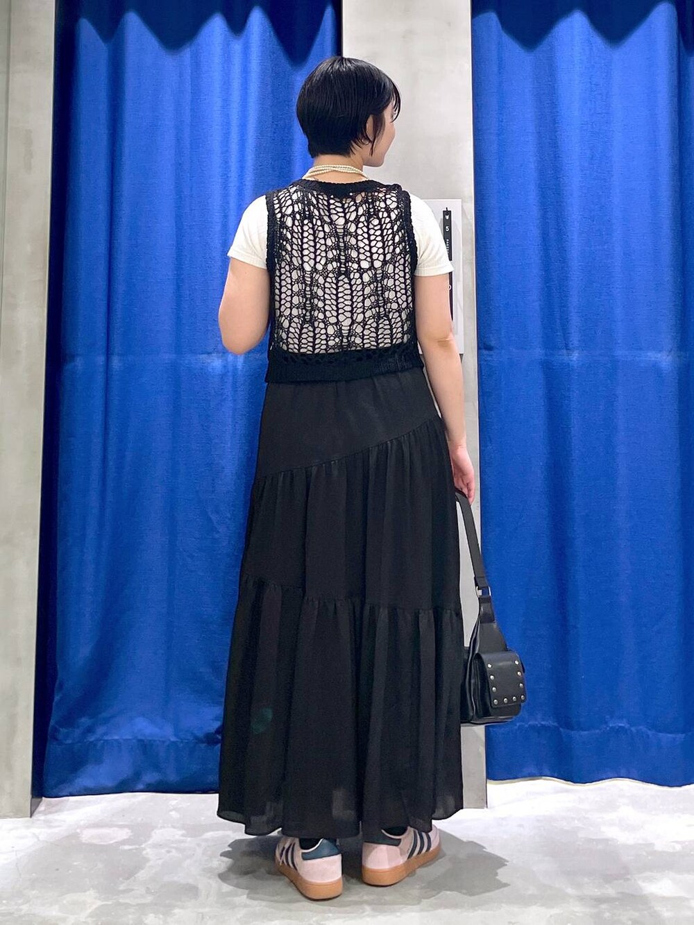 ブラック系のスカート、ブラック系のショルダーバッグ、ブラック系のTシャツ/カットソーを着用したレディースの夏コーディネートの5枚目の写真