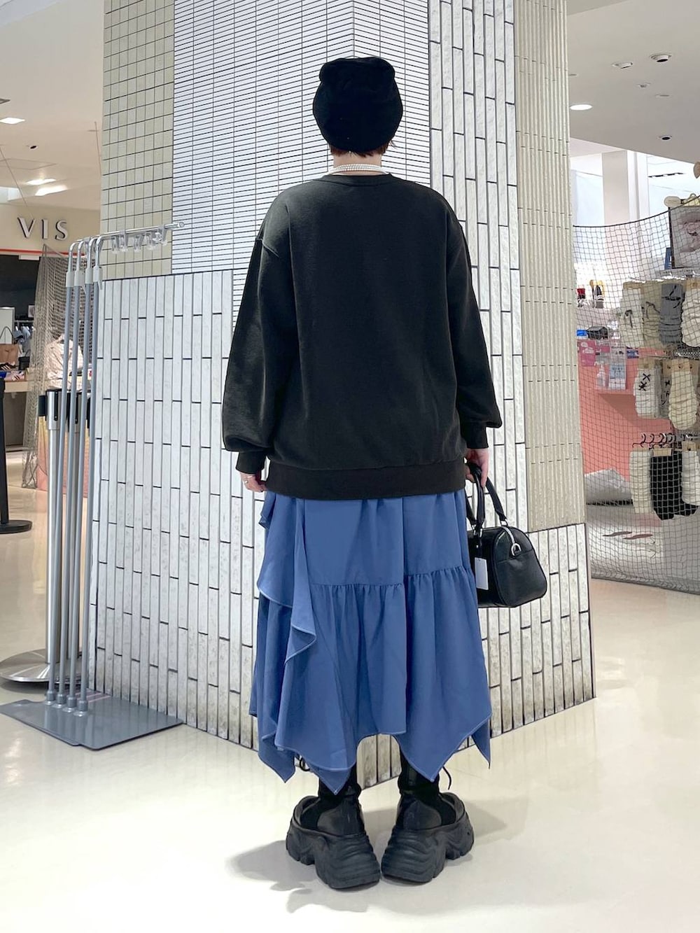 ブラック系のブーツ、ブルー系のスカート、グレー系のスウェットを着用したレディースの冬コーディネートの5枚目の写真