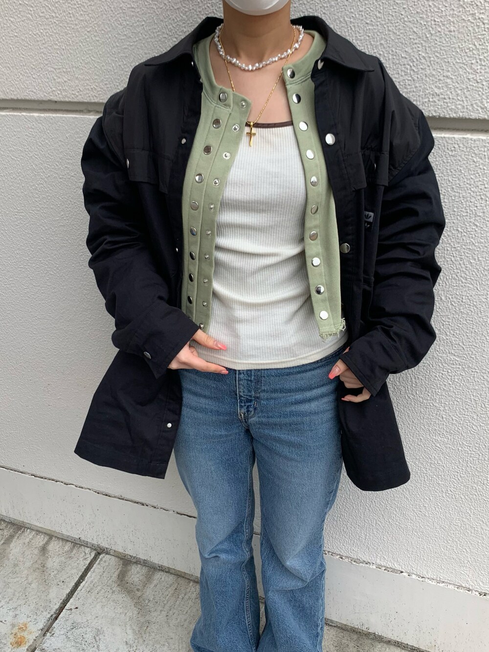 ホワイト系のTシャツ/カットソー、グリーン系のカーディガン/ボレロ、ブルー系のデニムパンツを着用したレディースの春コーディネートの3枚目の写真