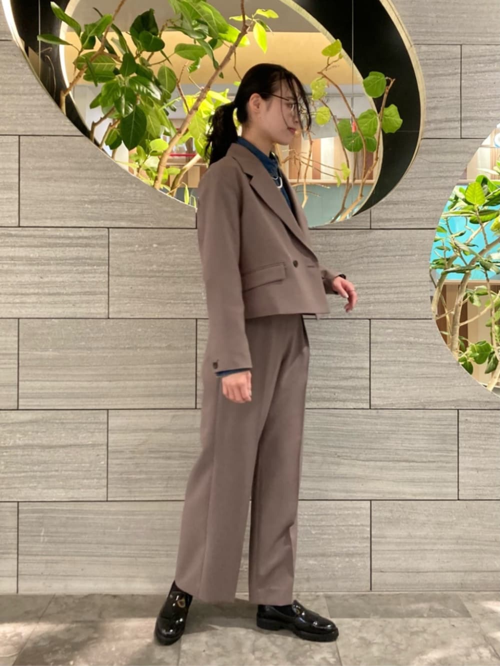 ブラウン系のスーツジャケット、ブラウン系のスーツパンツを着用したレディースの春コーディネートの3枚目の写真
