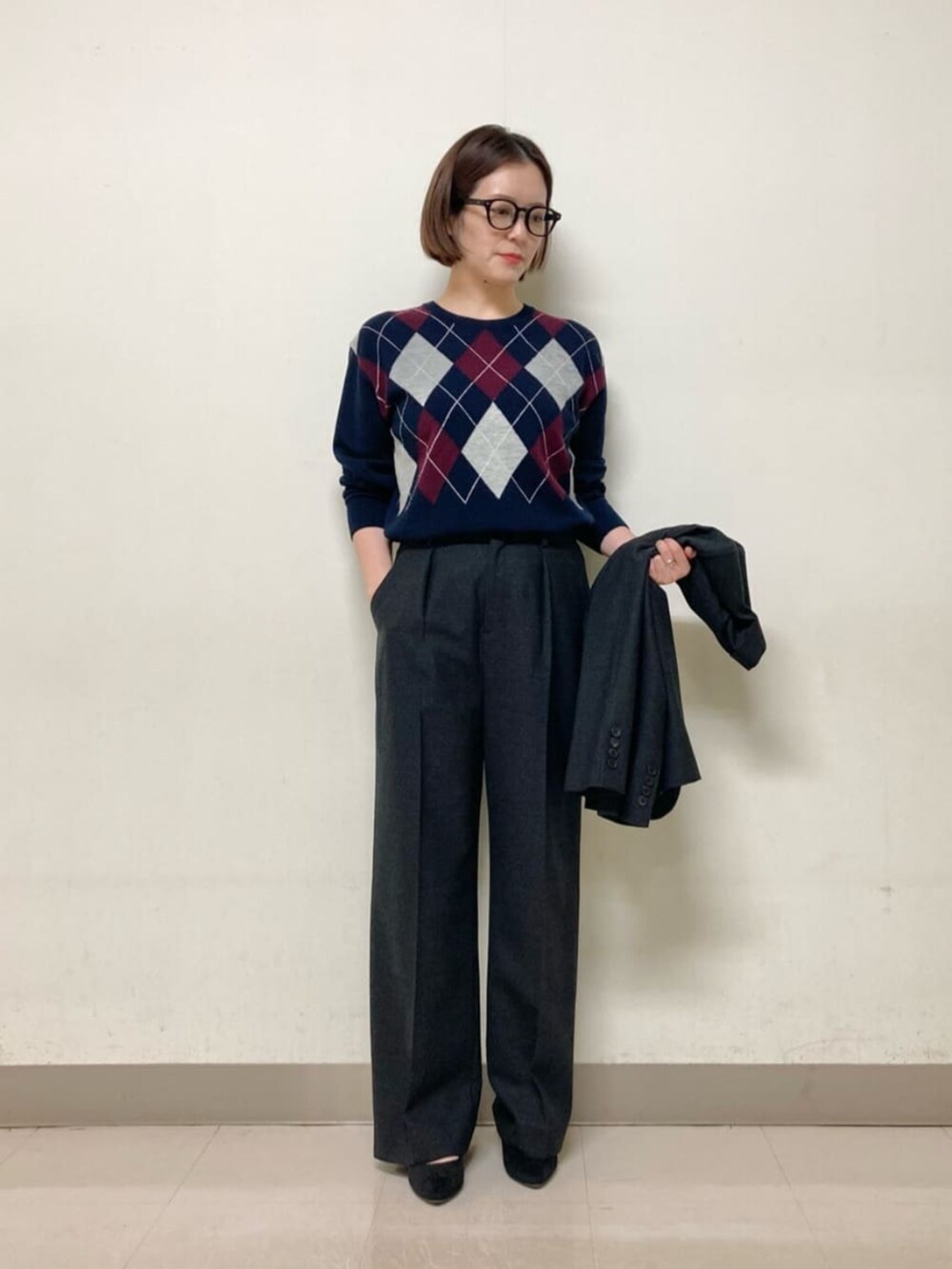 グレー系のスーツパンツ、グレー系のスーツジャケット、ブルー系のニット/セーターを着用したレディースの冬コーディネートの6枚目の写真