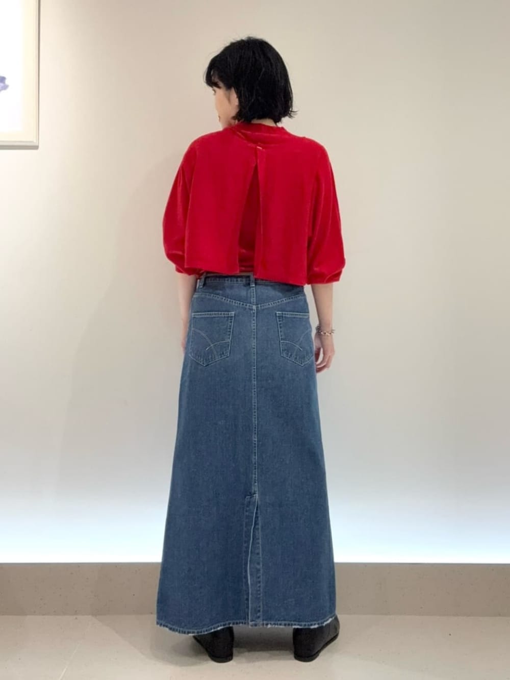 ブルー系のスカート、レッド系のアンサンブルを着用したレディースの秋コーディネートの4枚目の写真