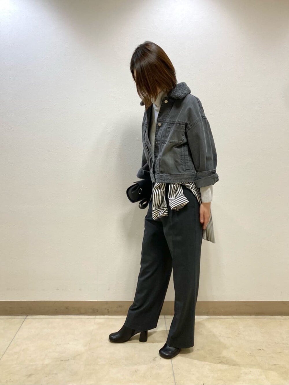 グレー系のその他パンツ、グレー系のデニムジャケット、ブラック系のブーツを着用したレディースの冬コーディネートの4枚目の写真