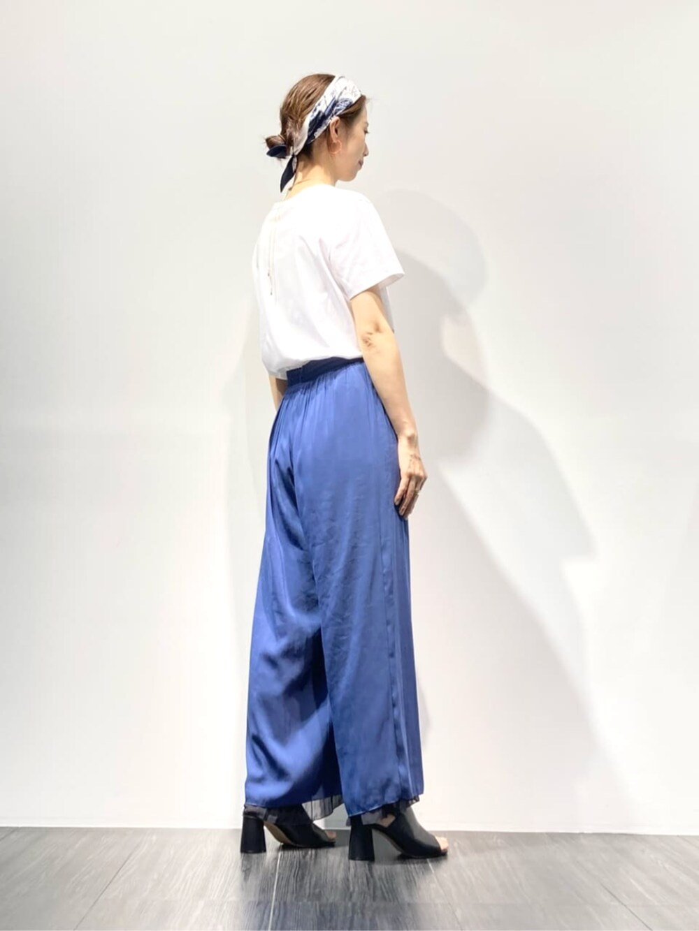 ブラック系のサンダル、ホワイト系のTシャツ/カットソー、ブルー系のその他パンツを着用したレディースの夏コーディネートの4枚目の写真