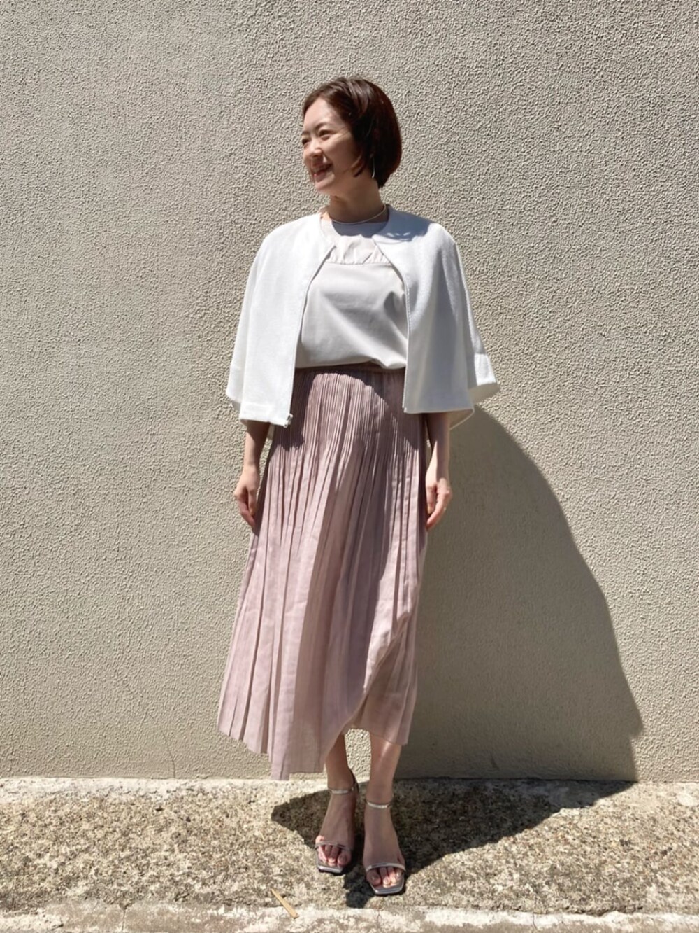 ホワイト系のTシャツ/カットソー、ホワイト系のブルゾン、ピンク系のスカートを着用したレディースの夏コーディネートの2枚目の写真